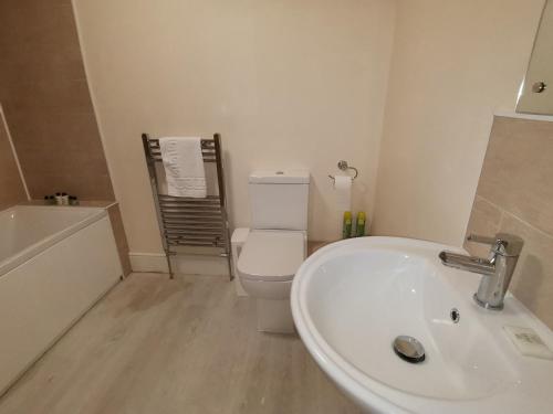 a bathroom with a white sink and a toilet at The Cross Inn in Hebden Bridge