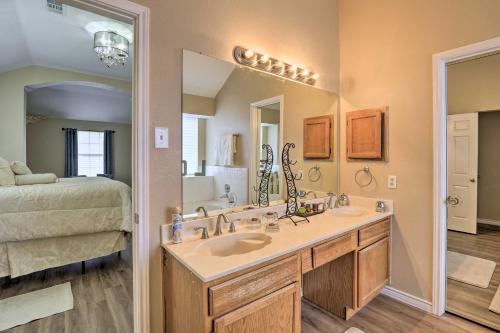 a bathroom with a sink and a large mirror at Charming Family Home about 16 Mi to Dtwn Dallas! in Cedar Hill
