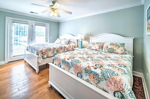 a bedroom with two beds and a ceiling fan at 1 Mi to Beach and Hot Tub Murrells Inlet Retreat! in Myrtle Beach
