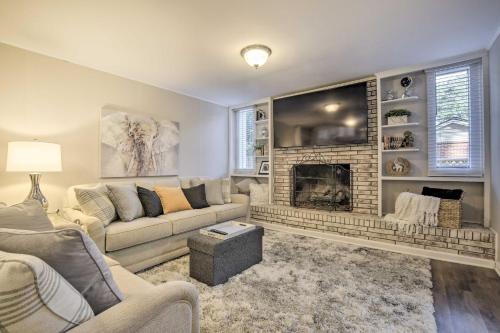 a living room with a couch and a fireplace at Recently Renovated Raleigh Retreat with Patio! in Raleigh