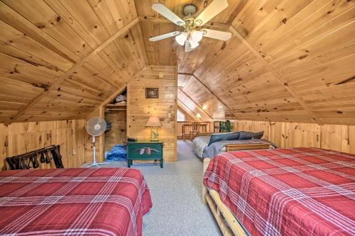 a bedroom with two beds and a ceiling fan at Lakefront Hawks Getaway - Fire Pit and Kayaks! in Hawks