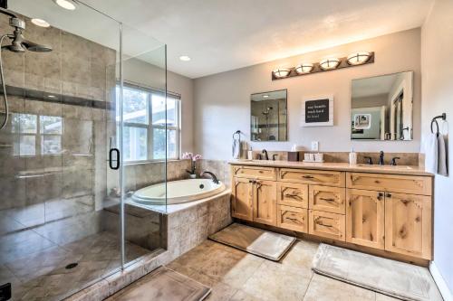 a bathroom with a tub and a sink and a shower at Reno Home with Private Yard and Hot Tub in Reno