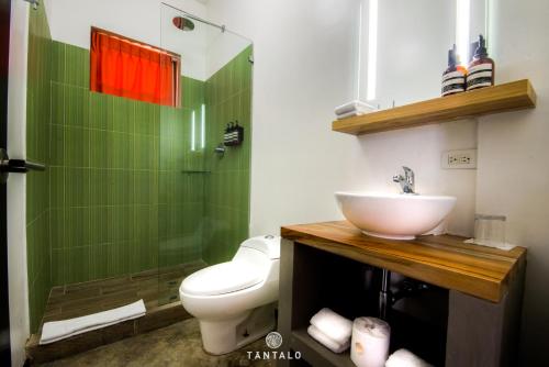 a bathroom with a sink and a toilet and a shower at Tantalo Hotel - Kitchen - Roofbar in Panama City