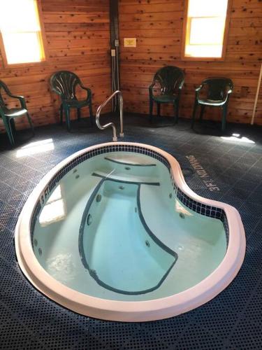 a jacuzzi tub in a room with chairs at 2 Bedroom 2 Bathroom - Blue Knob All Season Resort Condo in Claysburg