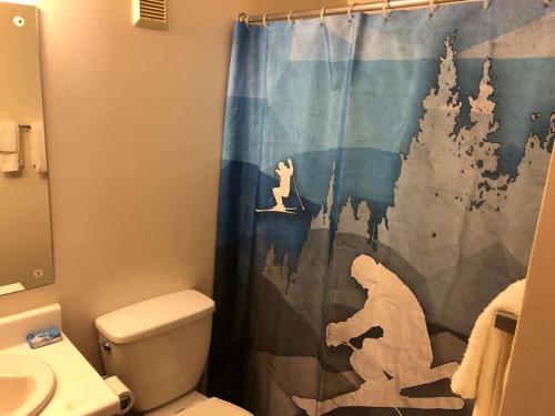 a bathroom with a shower curtain with a dog on it at 2 Bedroom 2 Bathroom - Blue Knob All Season Resort Condo in Claysburg