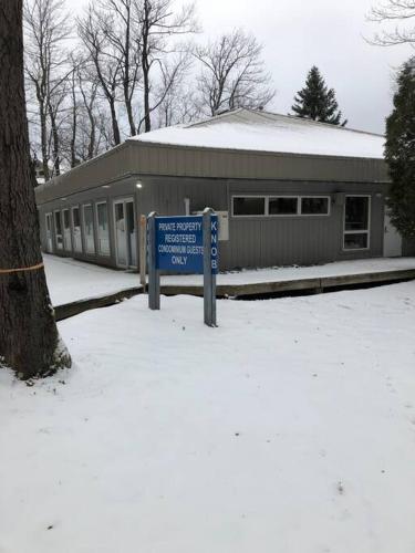 a sign in the snow in front of a building at 2 Bedroom 2 Bathroom - Blue Knob All Season Resort Condo in Claysburg