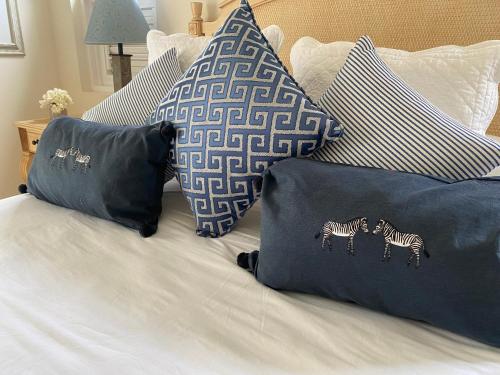 a bed with blue pillows with zebras on it at Barbados Luxury Villa with Pool in Saint James