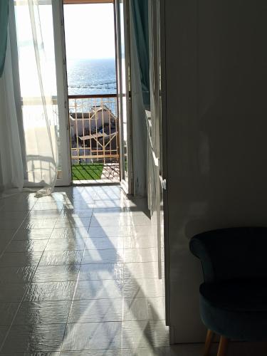 a room with a door leading to the ocean at Blue Eyes L'INCANTESIMO SUL MARE in Gaeta