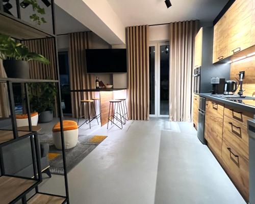 a kitchen and living room with a table and chairs at Premium Apartment Eleven in Zator