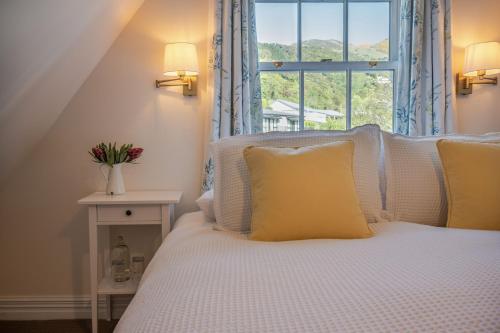 a bedroom with a bed with a large window at French Bay House in Akaroa