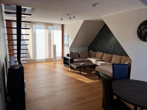 a living room with a couch and a table at Schöne Wohnung mitten im Zentrum in Bad Lippspringe