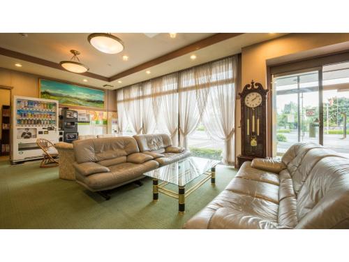 a living room with two couches and a clock at Hotel Tamano - Vacation STAY 41652v in Otawara