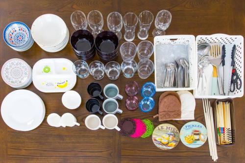 a table with plates and cups and wine glasses at Laulea in Yaka
