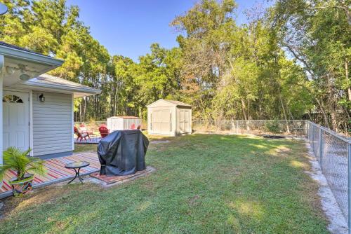 a backyard with a grill and a fence at Cloud 9 On The Coast Less Than 1 Mi to Beach! in Waveland