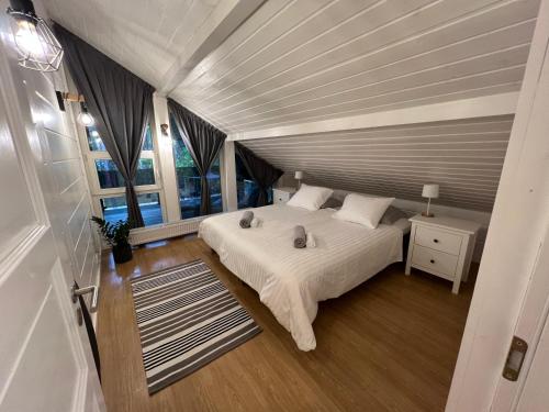 a bedroom with a bed and a large window at Jõiste Beach Villa in Jõiste