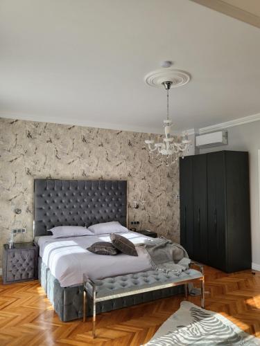 a bedroom with a large bed and a stone wall at Fancy Flats in Sibiu