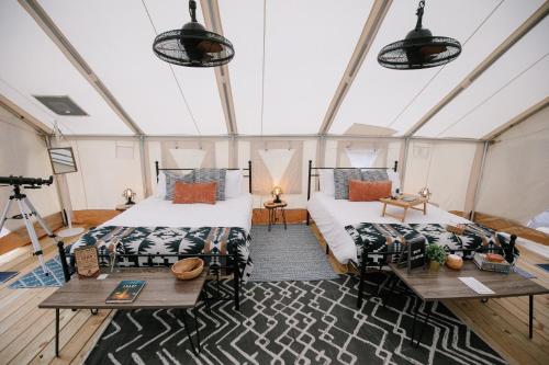 a room with two beds and a table and a camera at Timberline Glamping at Unicoi State Park in Helen