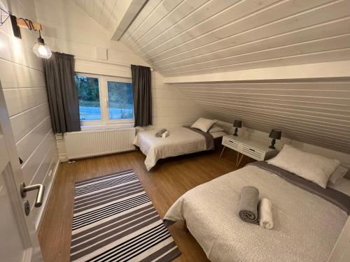 a room with two beds and a window at Jõiste Beach Villa in Jõiste