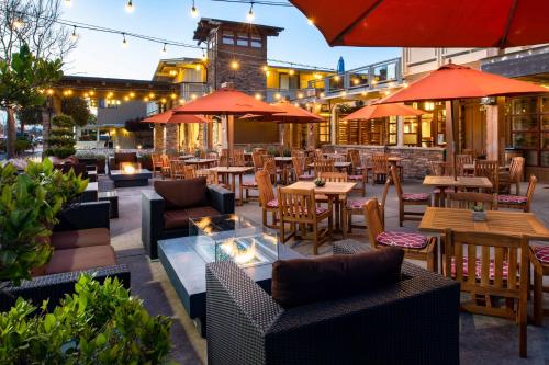 an outdoor restaurant with tables and chairs and umbrellas at The Lodge at Tiburon in Tiburon