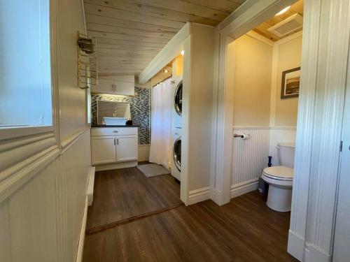 La salle de bains est pourvue d'un lave-linge et de toilettes. dans l'établissement Bespoke Lake Cottage, à New Minas