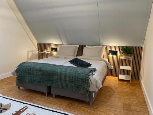 a bedroom with a large bed in a room at Copenhagen Residence in Harderwijk