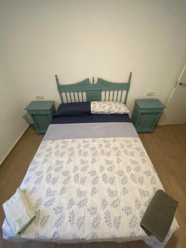 a bedroom with a bed with two end tables at CASA PAULA in Murcia