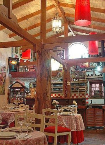 a restaurant with tables and chairs and red lights at Hotel La Calma De Rita - Pirque in Pirque
