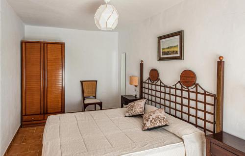 1 dormitorio con 1 cama grande y 1 silla en Awesome Apartment In Villa Del Rey With Kitchen, en Villa del Rey