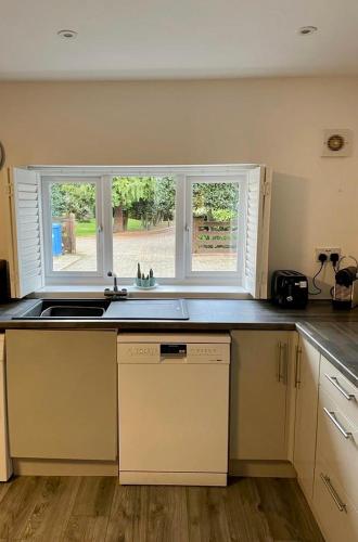 a kitchen with a sink and a window at La Casita in Hale