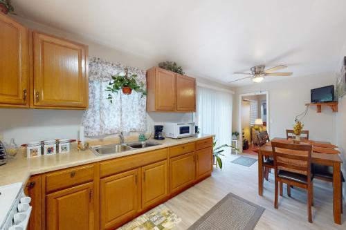 a kitchen with wooden cabinets and a dining table at Harmon House in Berlin