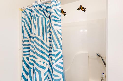 a bathroom with a blue and white shower curtain at Harmon House in Berlin