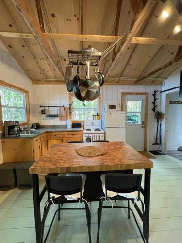 a kitchen with a large wooden table and chairs at Leland’s Lakehouse in Wolfville