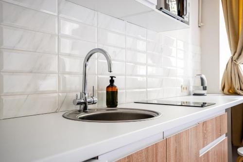 a kitchen sink with a bottle of wine on it at KayKay Apartments in Odesa