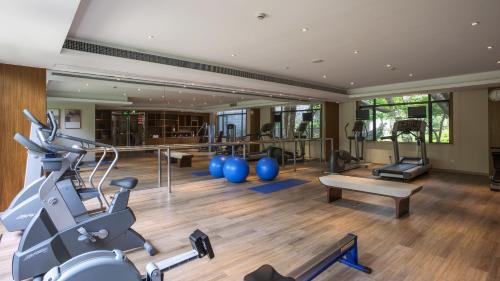 a gym with treadmills and exercise equipment in a building at Zhejiang Xizi Hotel in Hangzhou