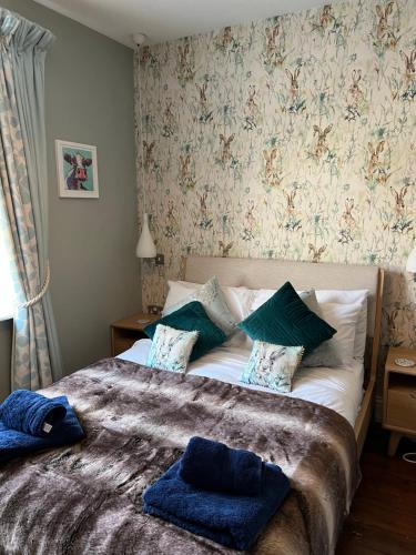 a bedroom with a bed with blue towels on it at Horse Market Cottage Kirkby Lonsdale in Kirkby Lonsdale