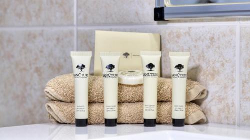 a group of four products sitting on top of a sink at Edward Parry Motel and Apartments in Tamworth