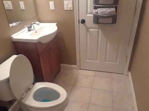 a bathroom with a toilet and a sink at Lovely 1-Bedroom/Near FedEx Field/Close to DC 