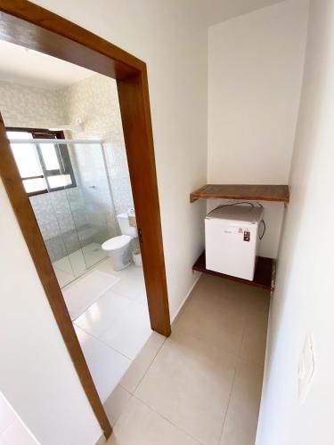 a bathroom with a shower and a toilet at Residencial Villa Cris - Jd. São Lourenço/Itaguaré in Bertioga