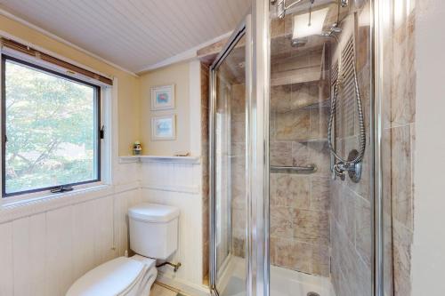 a bathroom with a shower and a toilet at Cape Cod-age in Falmouth