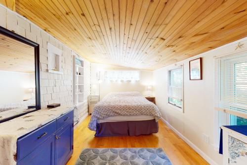 a bedroom with a bed and a wooden ceiling at Cape Cod-age in Falmouth