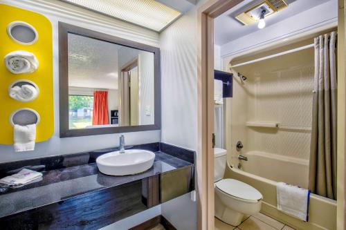 a bathroom with a sink and a toilet and a mirror at Motel 6-Ashland, VA in Ashland