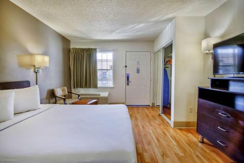 a hotel room with a large bed and a television at Studio 6-Phoenix, AZ - Deer Valley in Phoenix