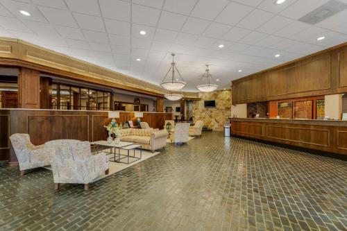 a lobby with chairs and tables in a building at Best Western Plus Wooster Hotel & Conference Center in Wooster