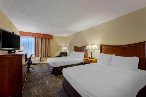 a hotel room with two beds and a flat screen tv at Best Western Plus Wooster Hotel & Conference Center in Wooster