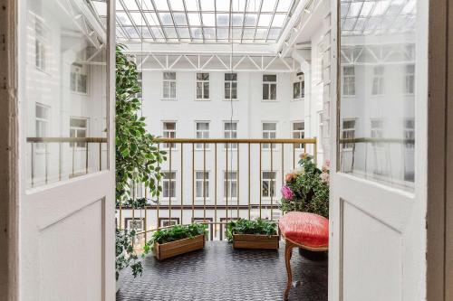 an open balcony with a red chair and plants at Best Western Hotel Bentleys in Stockholm