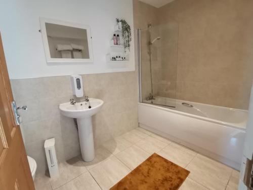 a bathroom with a sink and a toilet and a bath tub at The Cross Inn in Hebden Bridge