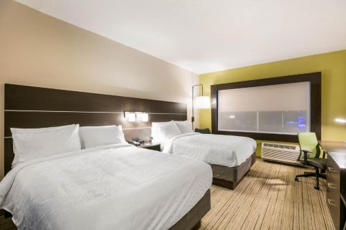 a hotel room with two beds and a window at Holiday Inn Express & Suites Jacksonville - Town Center by IHG in Jacksonville