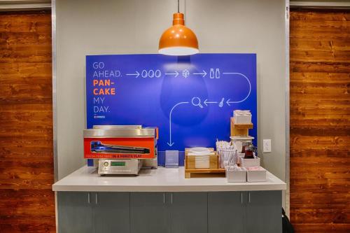a counter with a blue board with formulas on it at Holiday Inn Express & Suites Jacksonville - Town Center by IHG in Jacksonville