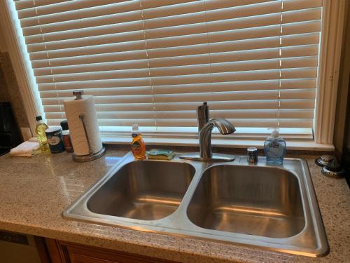 a kitchen sink in front of a window at LuxHome Suites in Mansion in Riverside