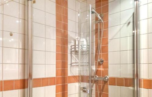 a shower with a glass door in a bathroom at 3 Bedroom Lovely Home In Adelsö in Adelsö
